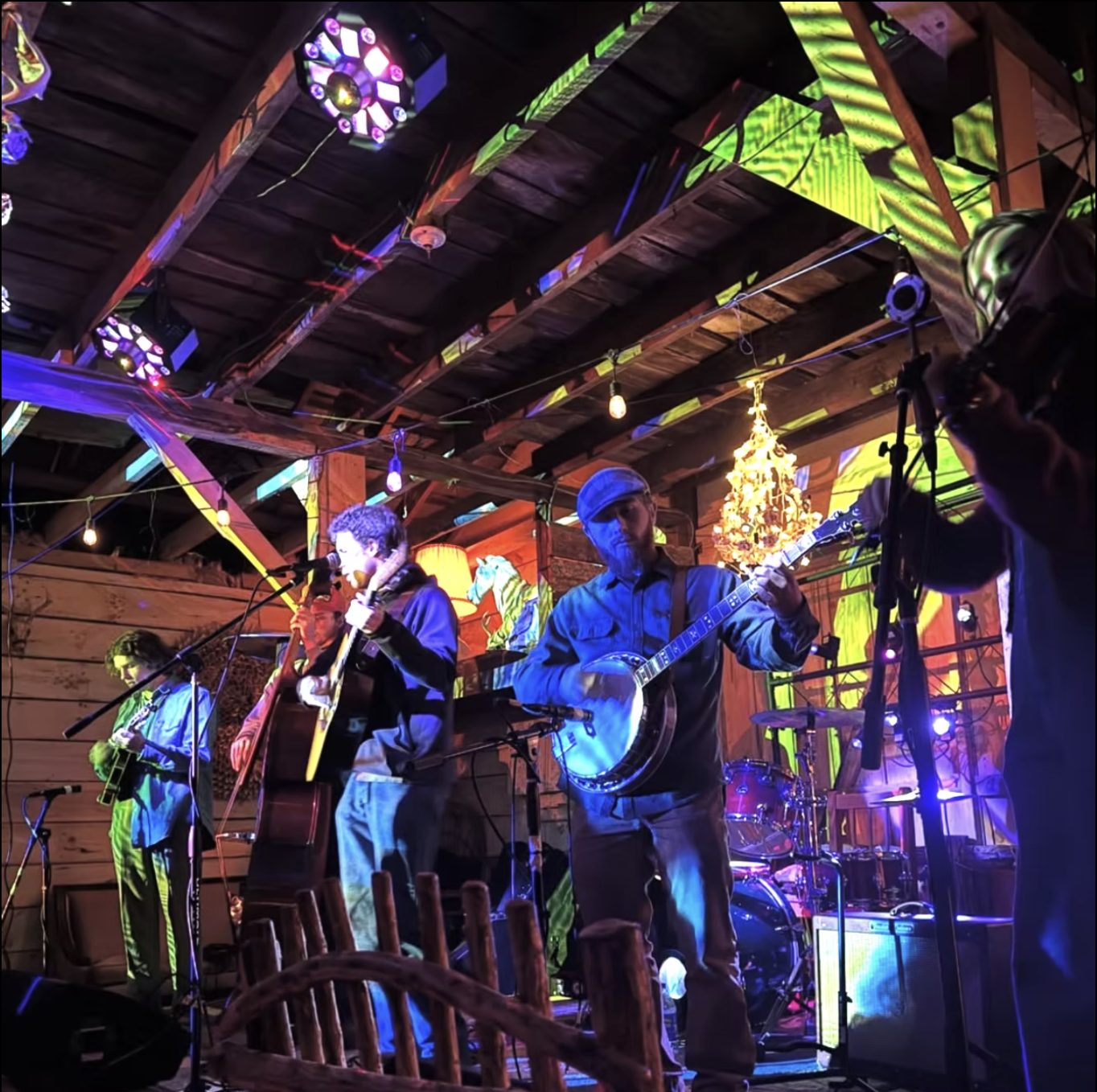 A bluegrass band under the projection-lit rafters at Betsy's Barn.