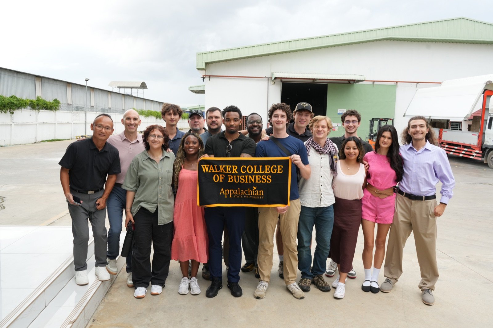 The Holland Fellows holding a Walker College of Business banner.