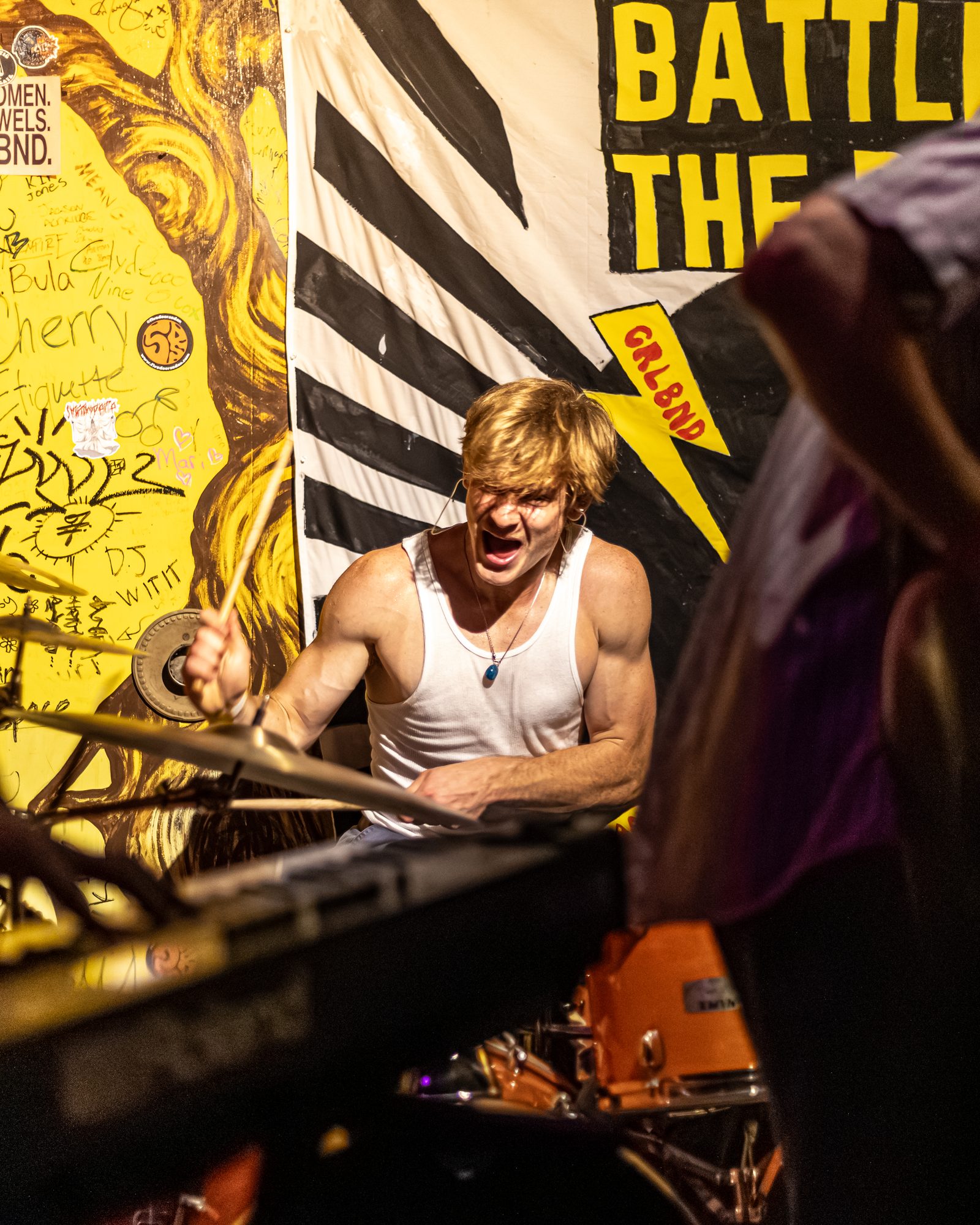 Oscar playing drums during a live performance.