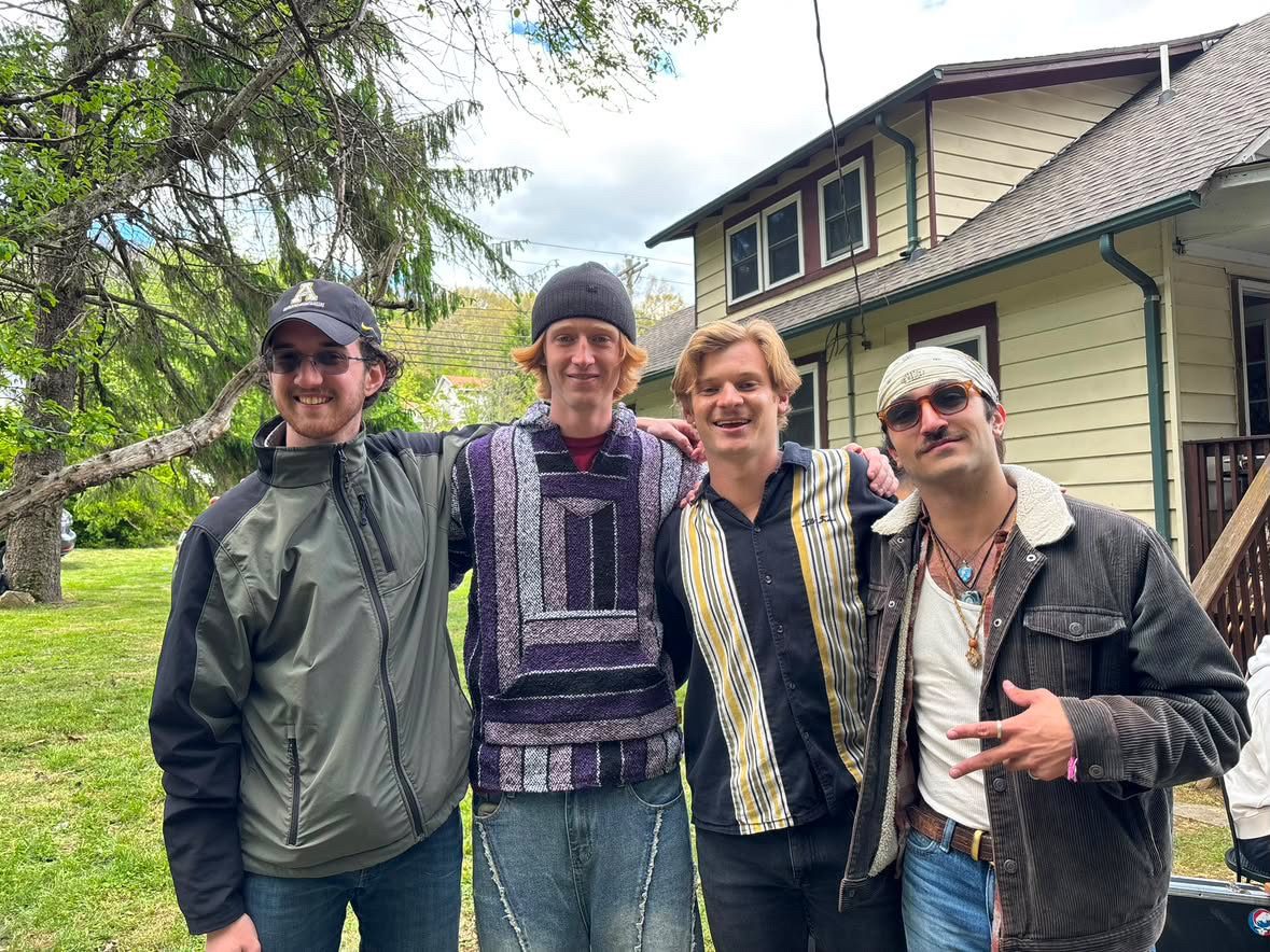 The four members of Altitude Sickness outside a house.